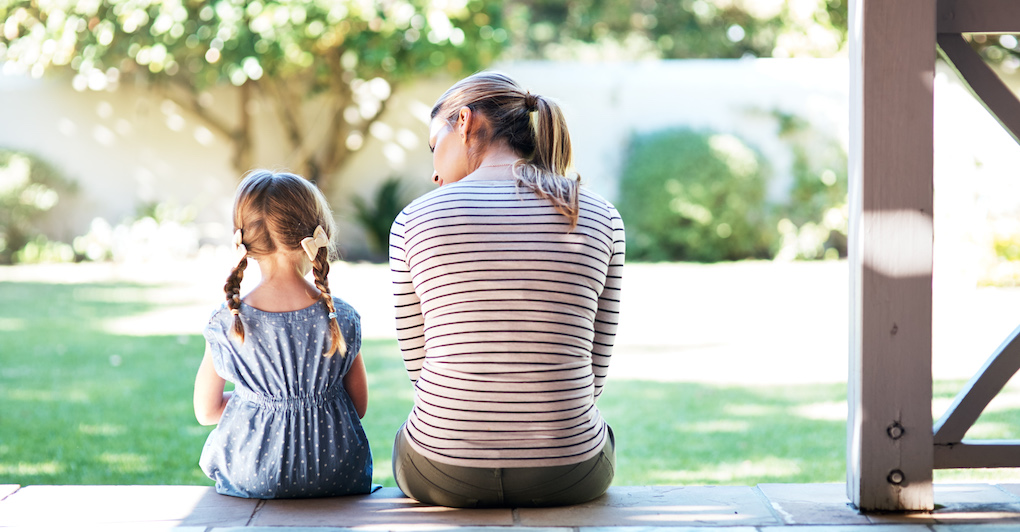 A woman and child sitting on the ground